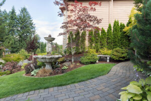 House with manicured front lawn and brick paver walkway created by hardscape contractors